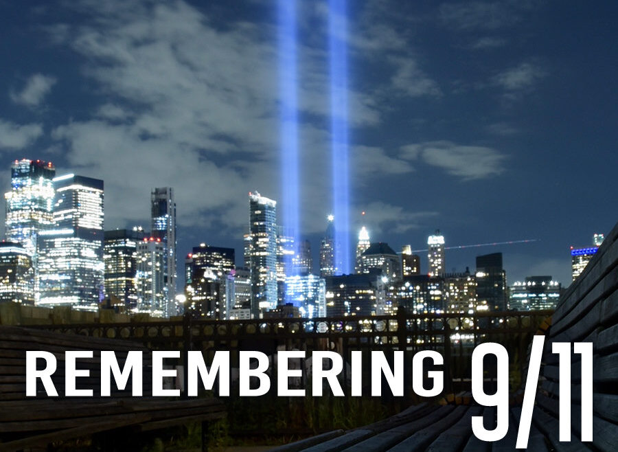 Remembering 9/11, image of two lights rising up from the Night time New York Sky line.