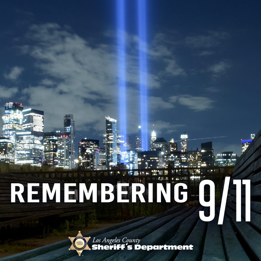 Remembering 9/11, image of two lights rising up from the Night time New York Sky line.