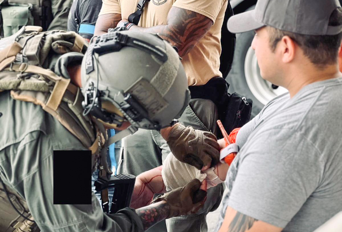 Image of Helicopter Medic placing a bandage on a person.