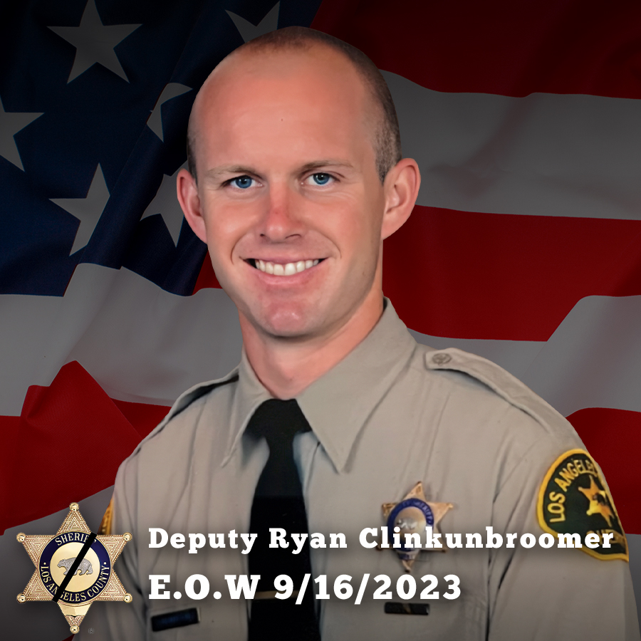 Image of Deputy Clinkunbroomer smiling. His portrait image is in front of a section of the american flag. He is wearing a tan longsleeve shirt with a black tie. There is a Sheriff badge over his left side. Words read: Deputy Ryan Clinkunbroomer, End of Watch 9-16-2023.